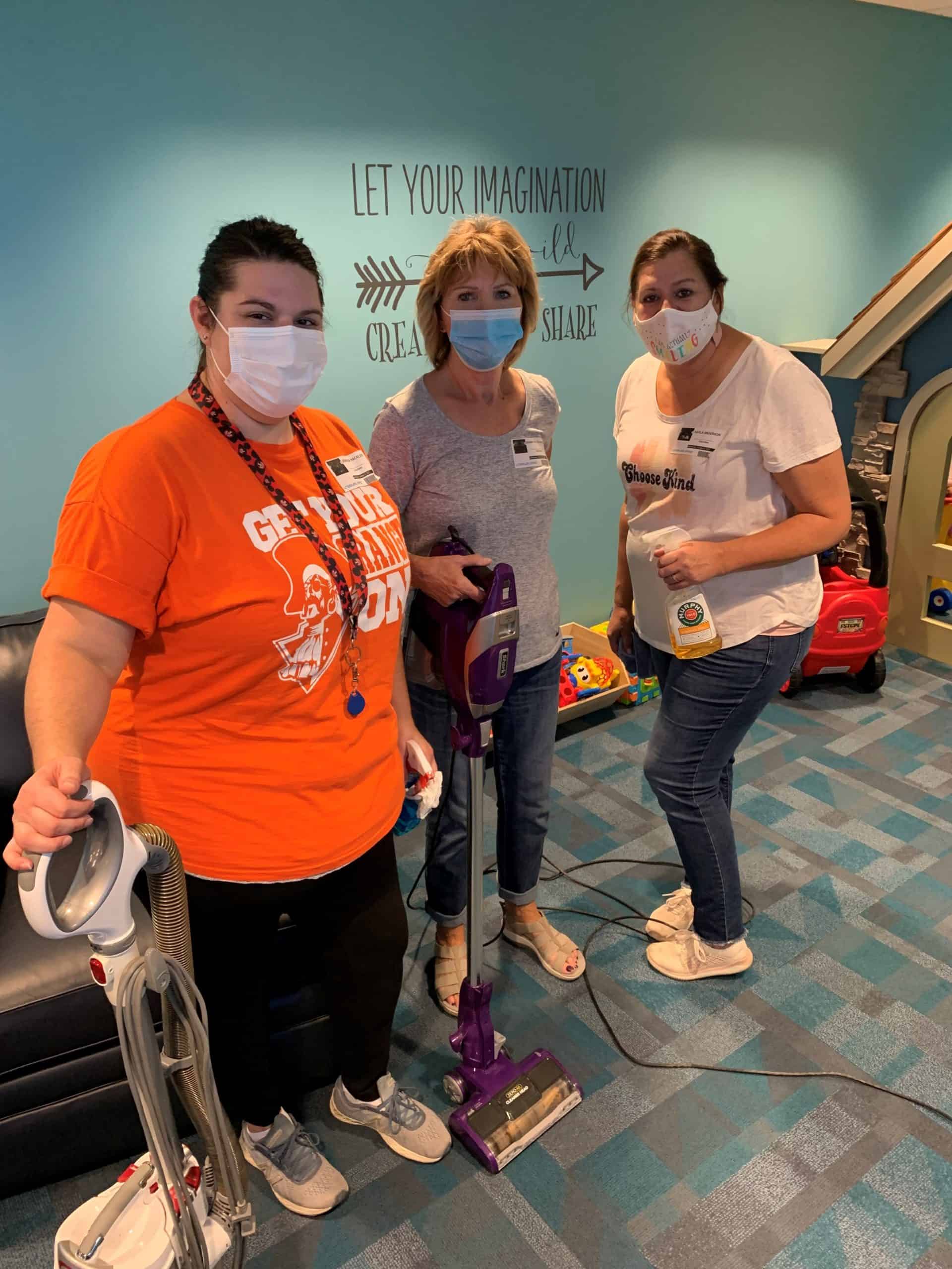 three women cleaning volunteers