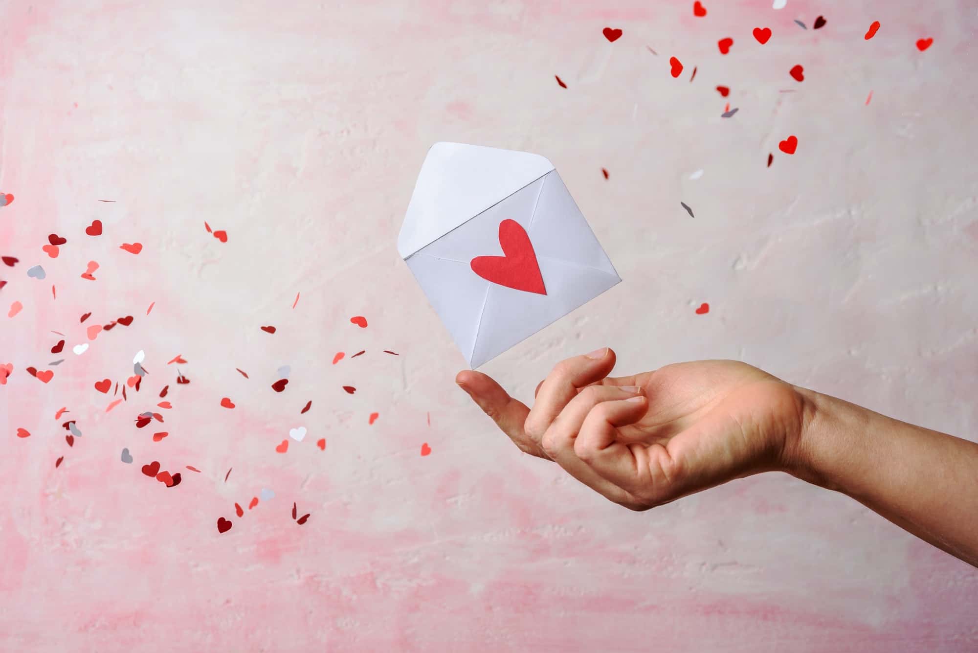 Envelope on hand with hearts